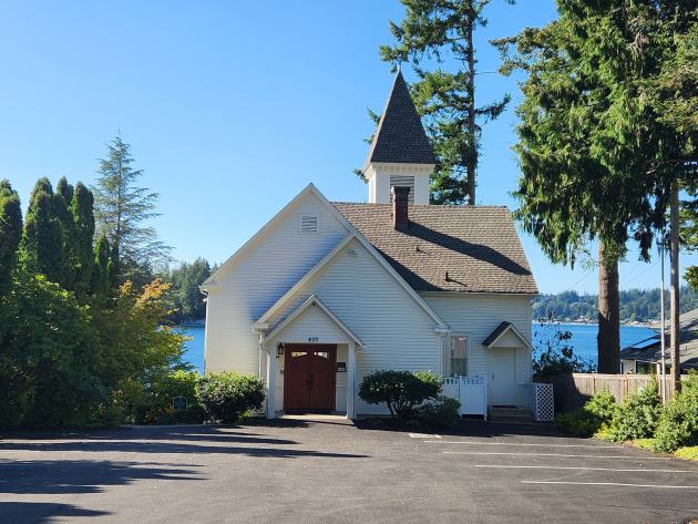 Fox Island Chapel from the front, with the water behind it